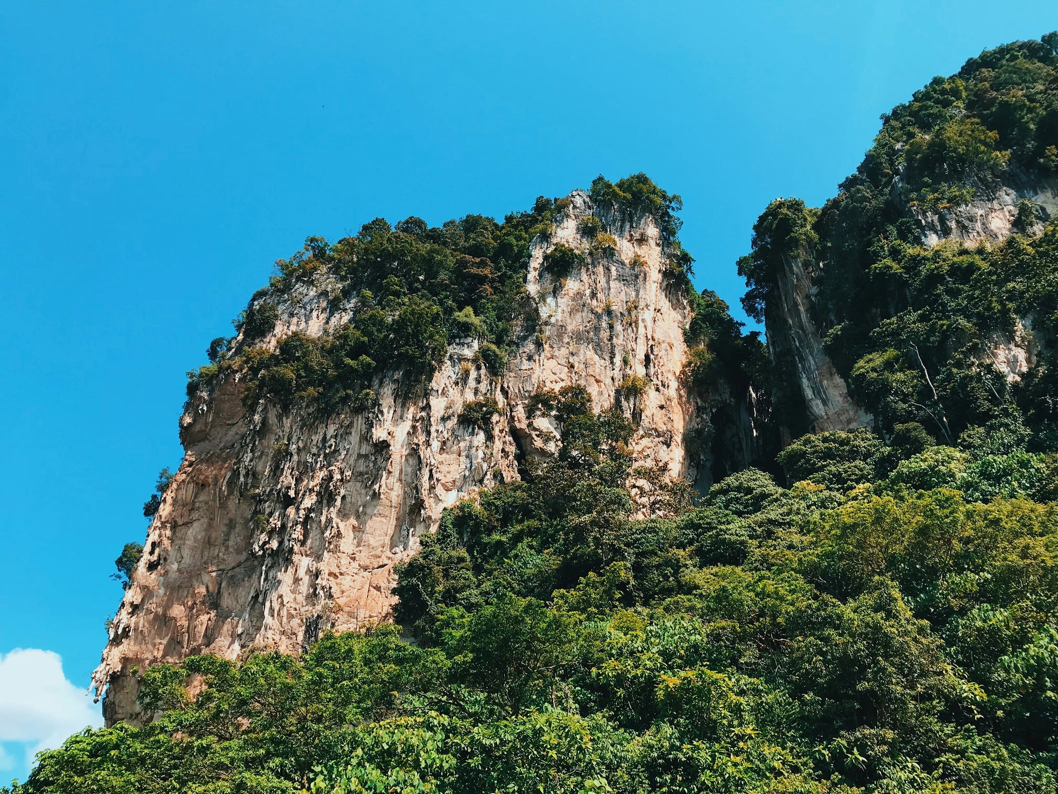 A scenic view of Batu Caves in Malaysia under a clear blue sky.