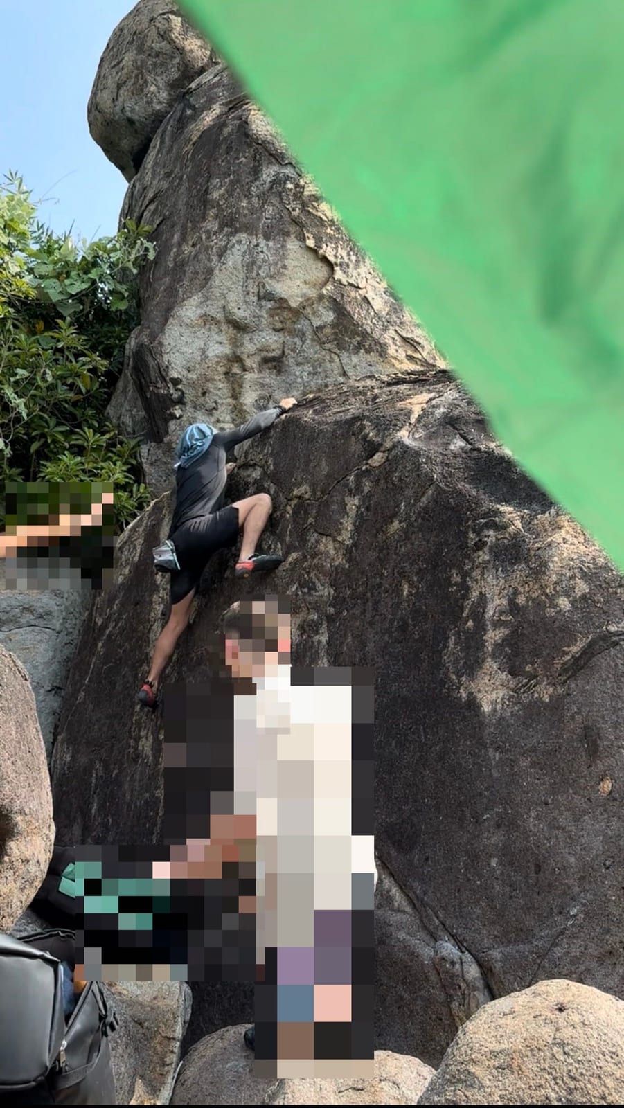 Bouldering with crash pads and spotters on the Bai Xep boulders, Son Tra, Da Nang