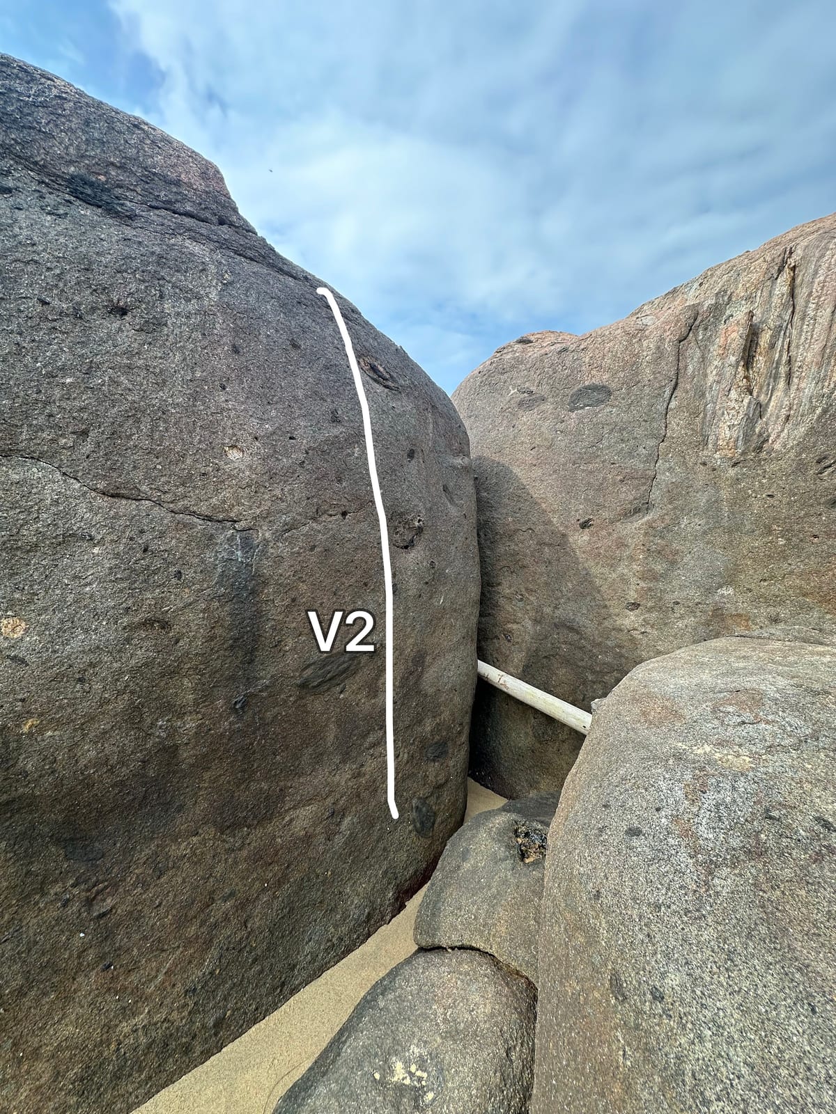 Topo line of a V2 stand start on a mono pocket at a low tide boulder, Bai Xep, Da Nang