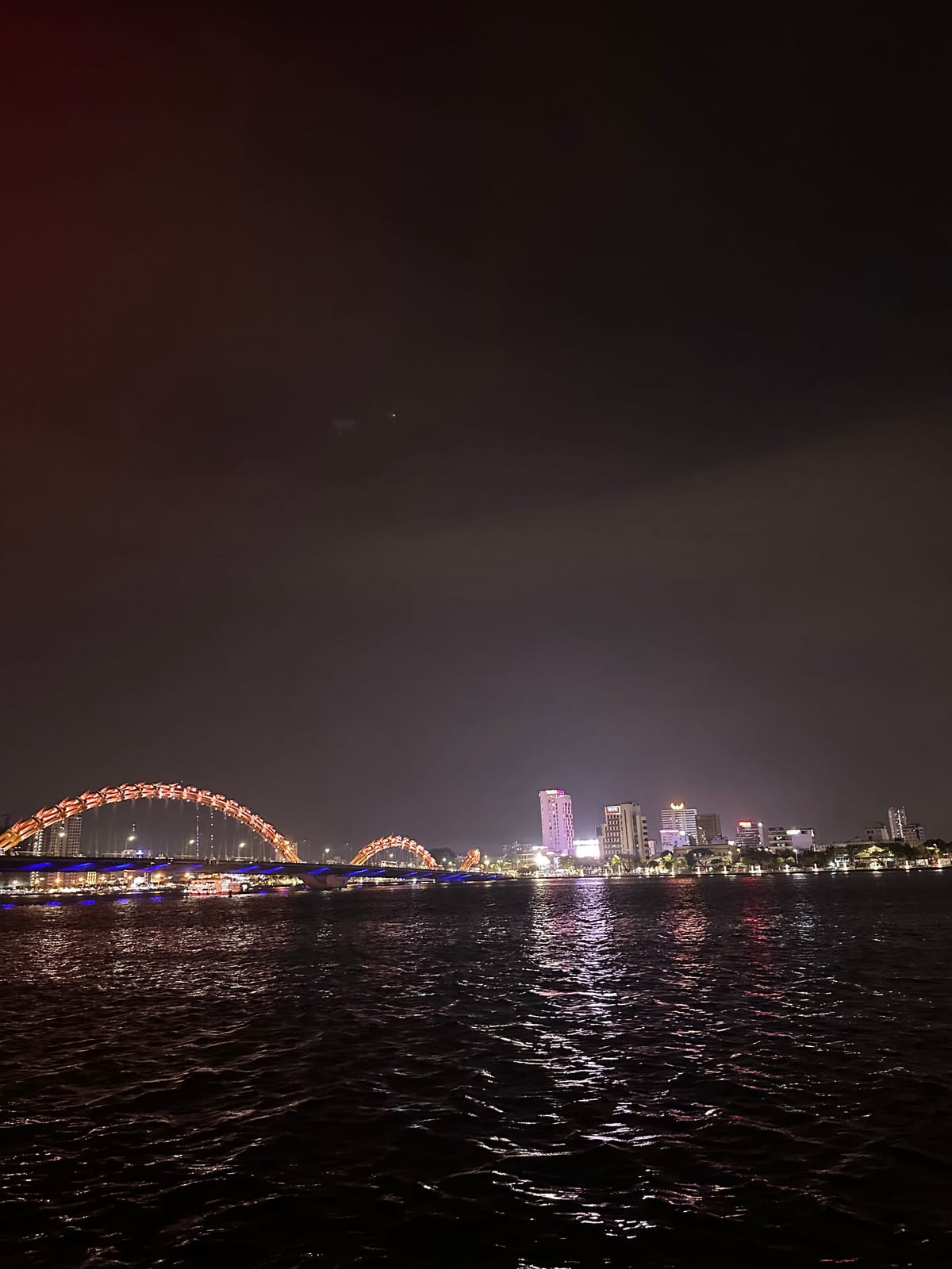 Dragon Bridge lit up at night over the Han River in Da Nang