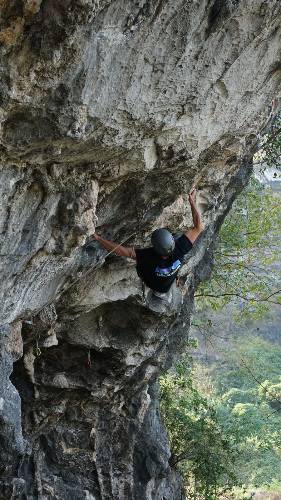 Climber turning the lip of the roof on Jab at Boxing Ring in the Sky, Yangshuo