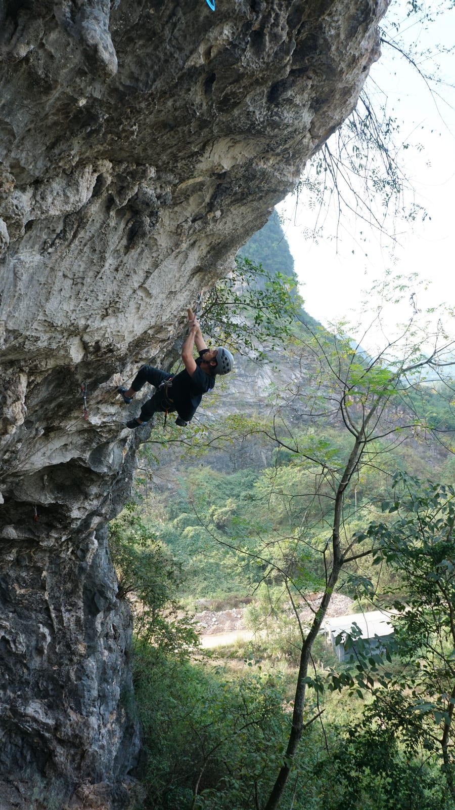 Roof climbing on Jab 7a+ at Boxing Ring in the Sky crag, Yangshuo