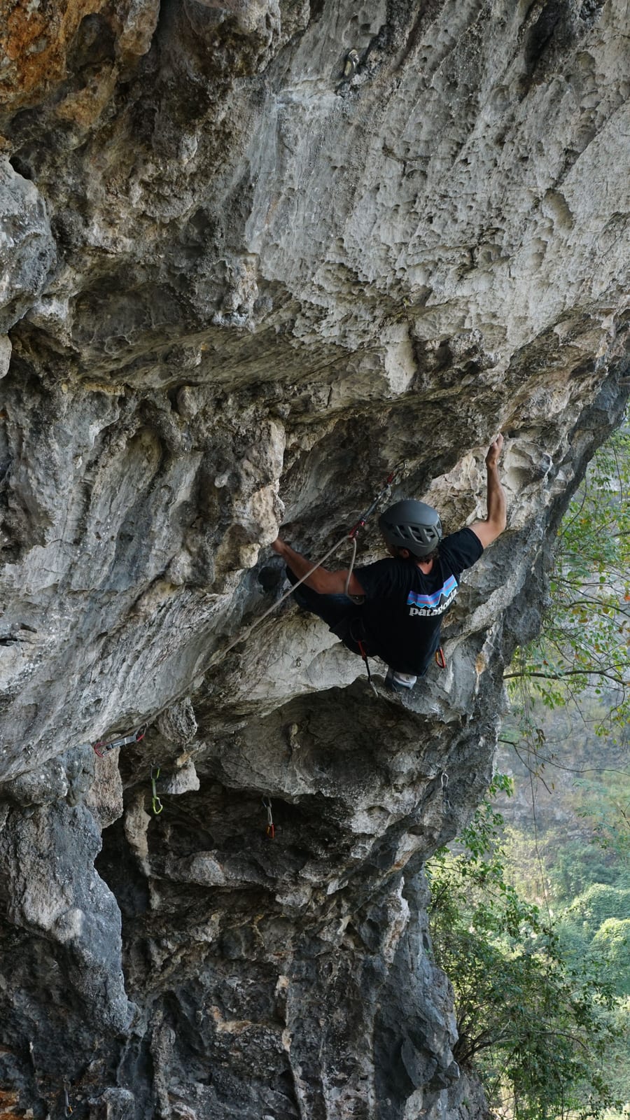 Climber pulling on a tufa feature on Jab at Boxing Ring in the Sky, Yangshuo