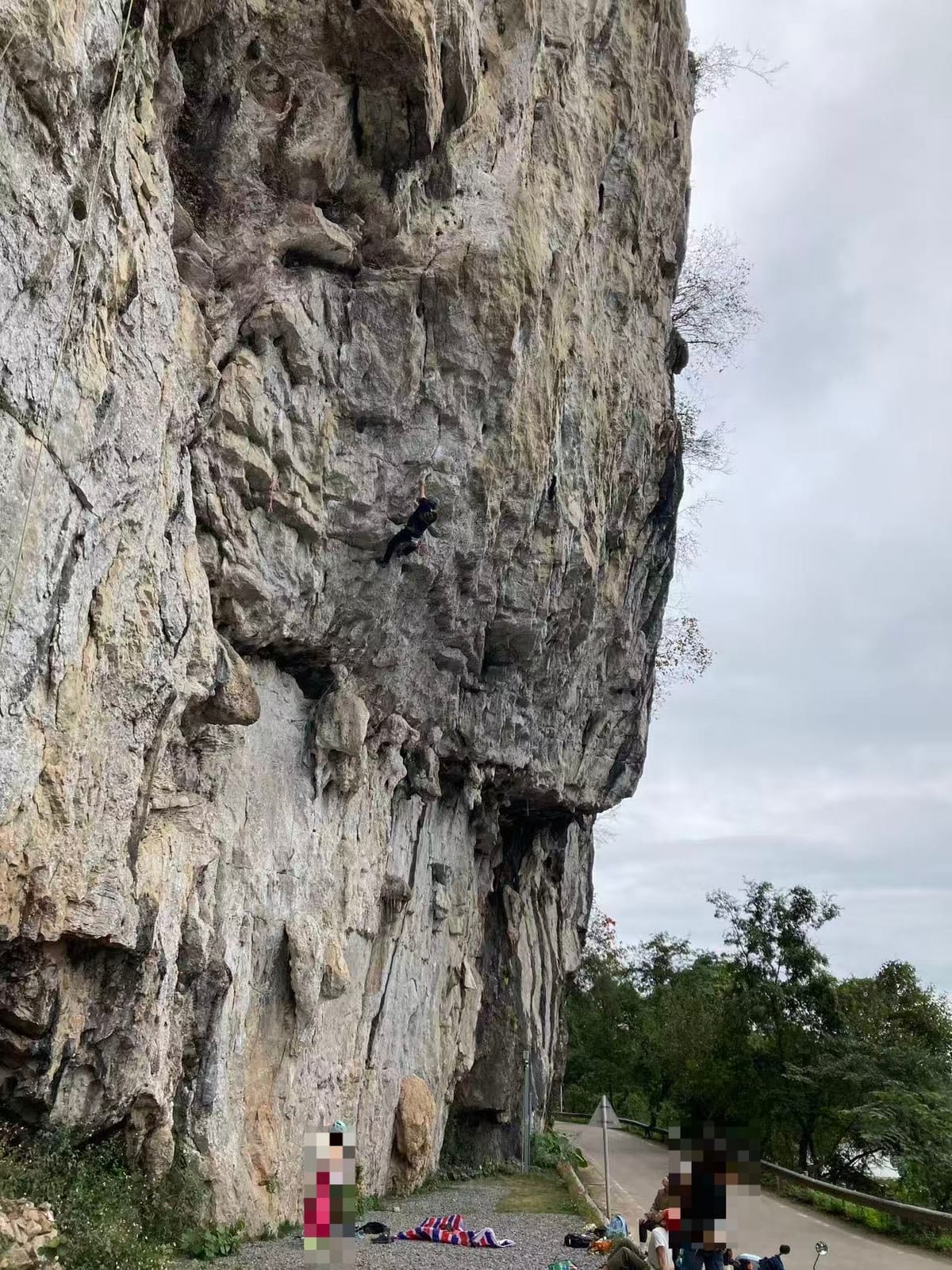 The overhanging prow at Riverside crag with climbers at the base, Yangshuo