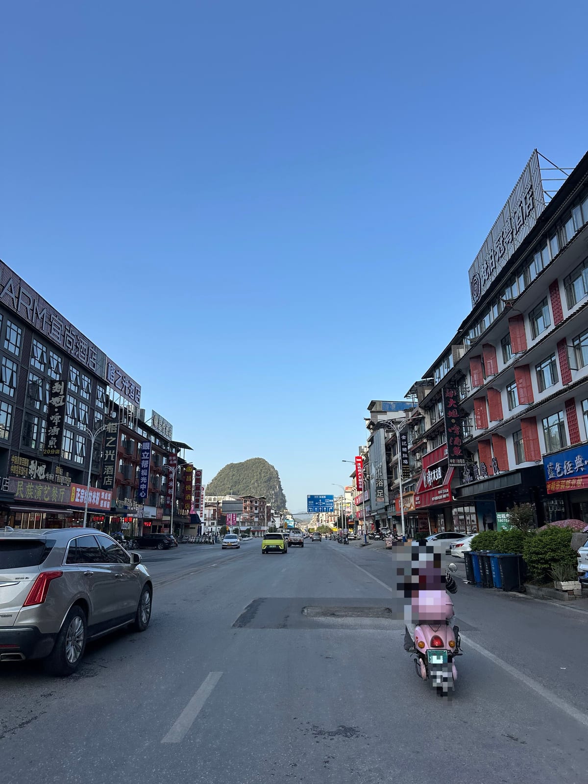 Riding through Yangshuo town on the way to the climbing crags, Guangxi, China