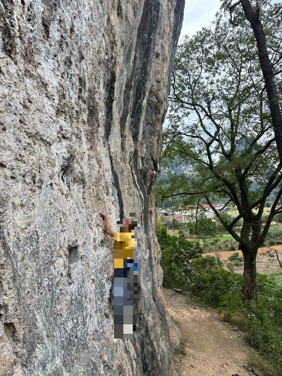 Climber on a sport route at Spearhead crag near Yangshuo
