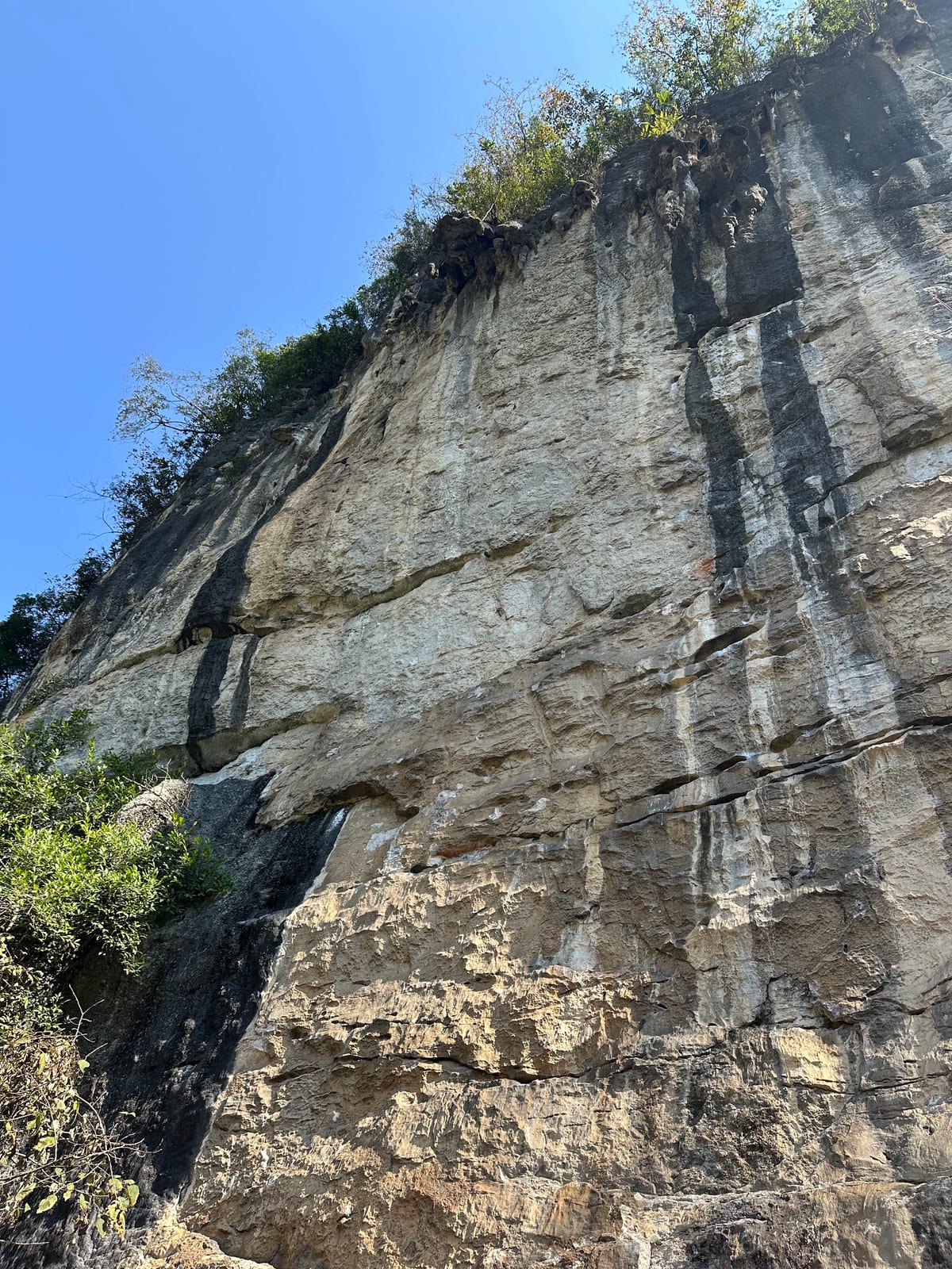 The main wall of The White Cliff crag, Yangshuo, with vertical technical routes
