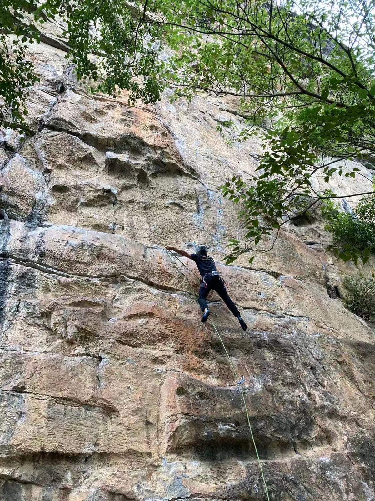 Climber on the lower section of a 6b+ route at Twin Gates, Yangshuo