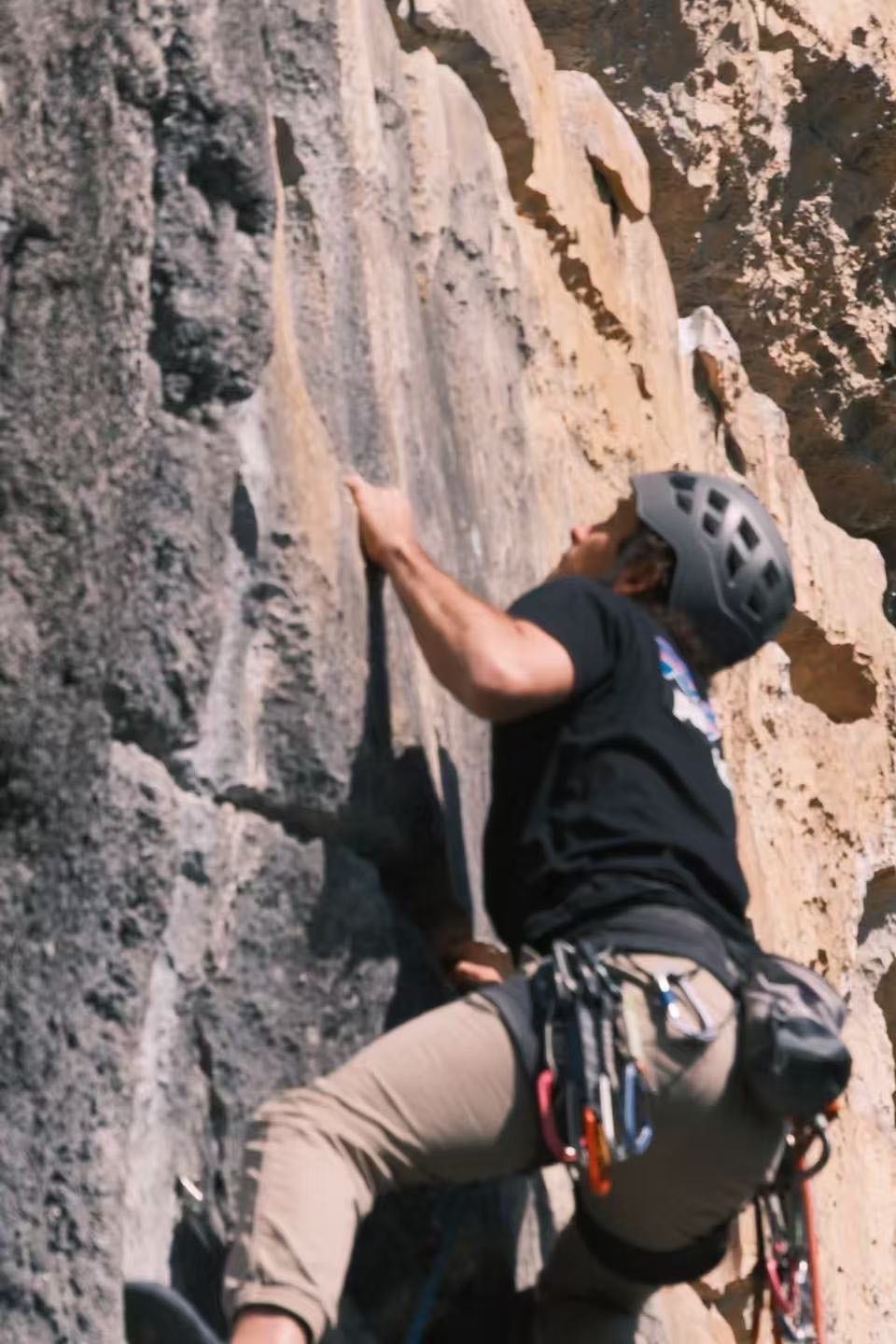 Close view of a climber on small crimps at Wine Bottle crag, Yangshuo, China